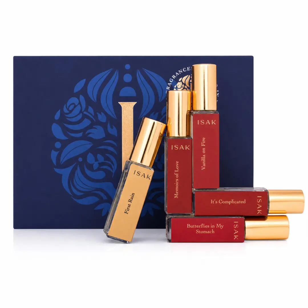 Perfume set with gold-capped ISAK bottles, red labels, and a boxed gift set