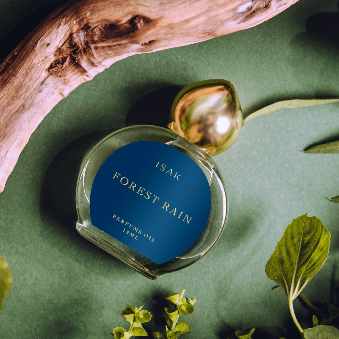 Forest Rain perfume oil bottle, 12ml, close-up clear glass with gold cap.