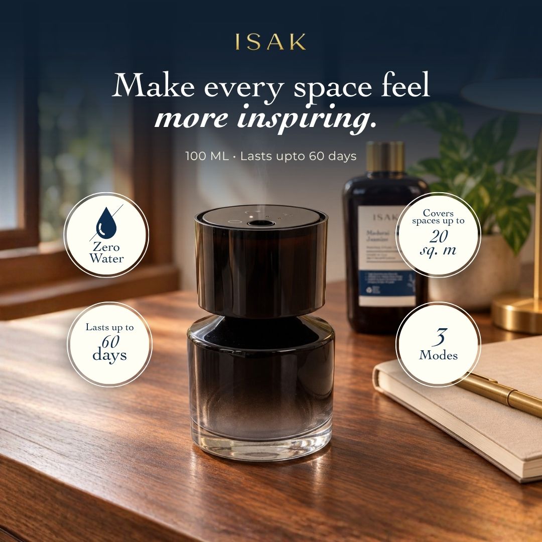 Cordless aroma oil diffuser with dark glass base and fragrance oil bottle, front view