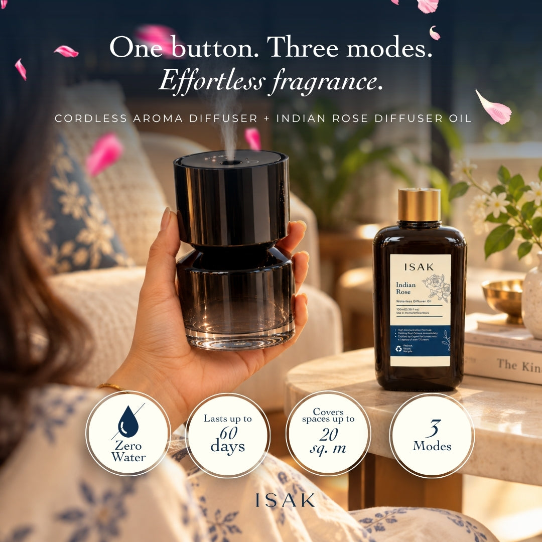 Hand holding black cordless aroma diffuser with Indian Rose fragrance oil bottle, 100ml