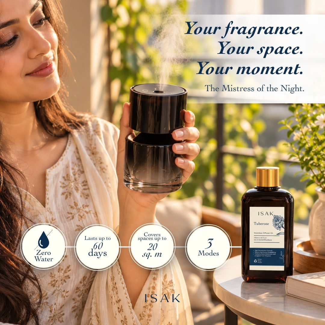 Cordless aroma diffuser held in hand with tuberose fragrance oil bottle, black and gold