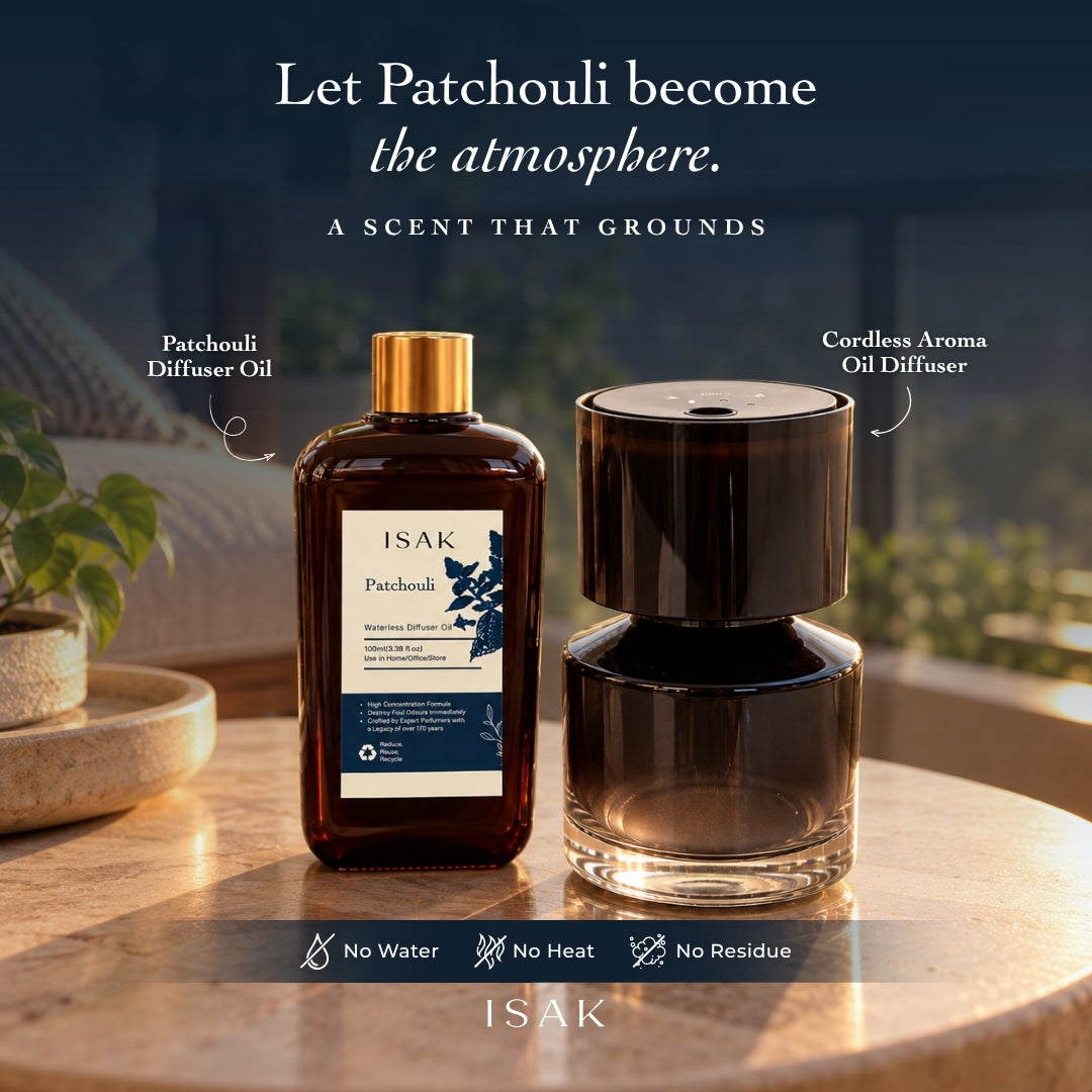 Cordless aroma diffuser and patchouli fragrance oil set on a table, glossy dark finish