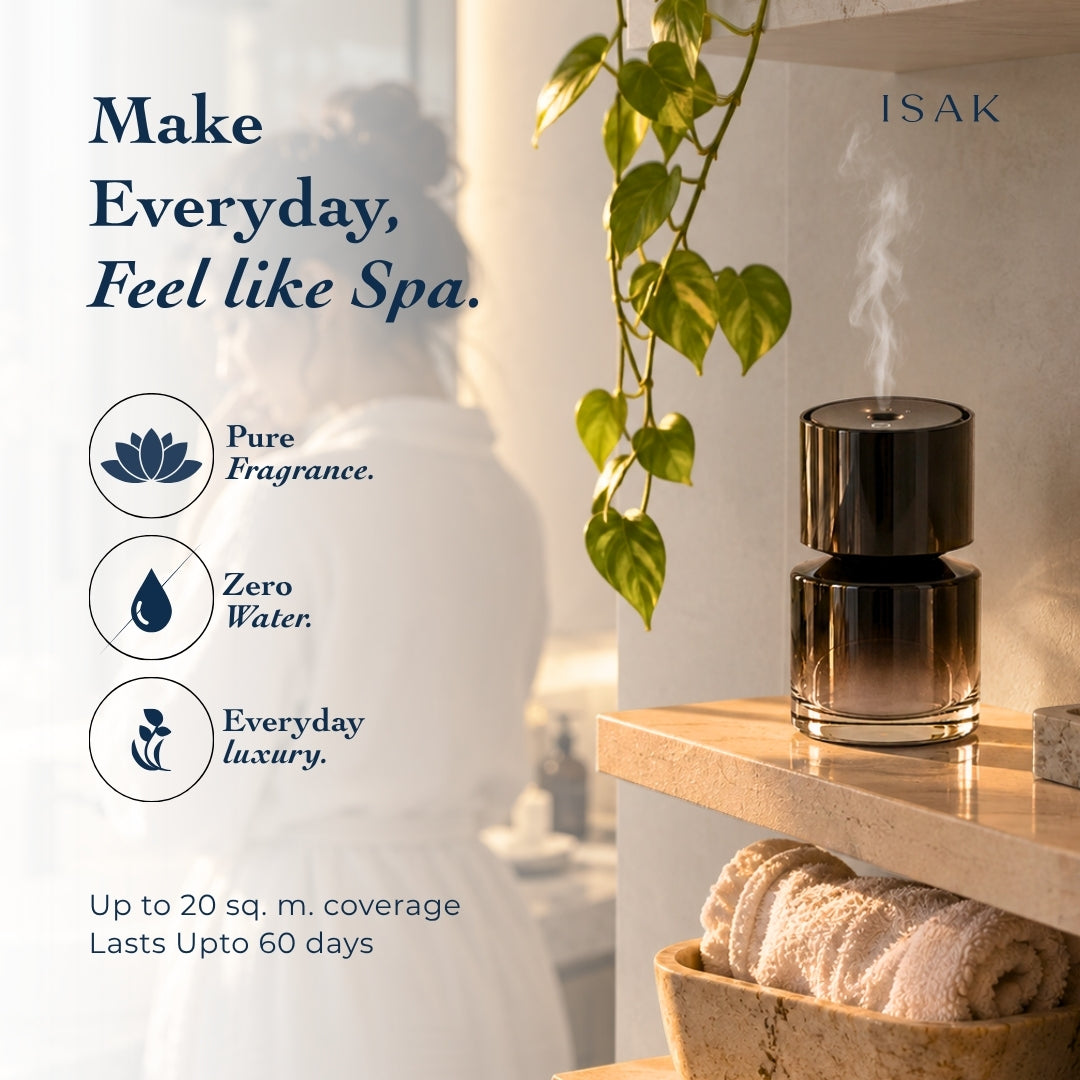 Isak aroma diffuser on countertop, glossy black cylinder with gold lid and rising vapor