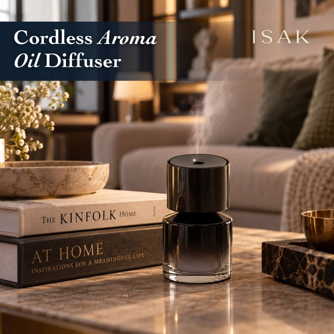 Isak cordless aroma oil diffuser, glossy black cylinder releasing a fine vapor cloud