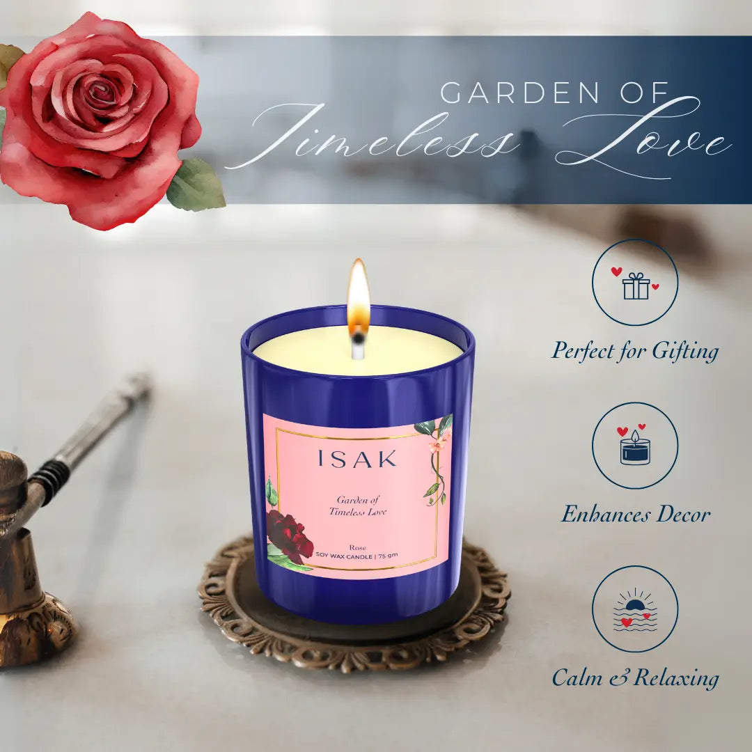 Blue glass scented candle with rose label and burning wick flame