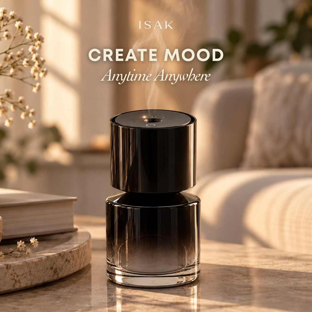 Isak aroma diffuser, glossy black cylinder with gold top and visible mist vent
