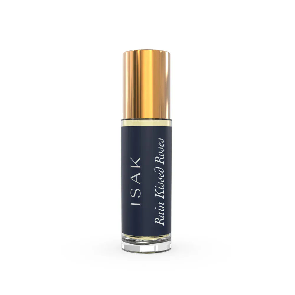 Rain Kissed Roses Attar mini roll-on bottle with gold cap, dark blue glass