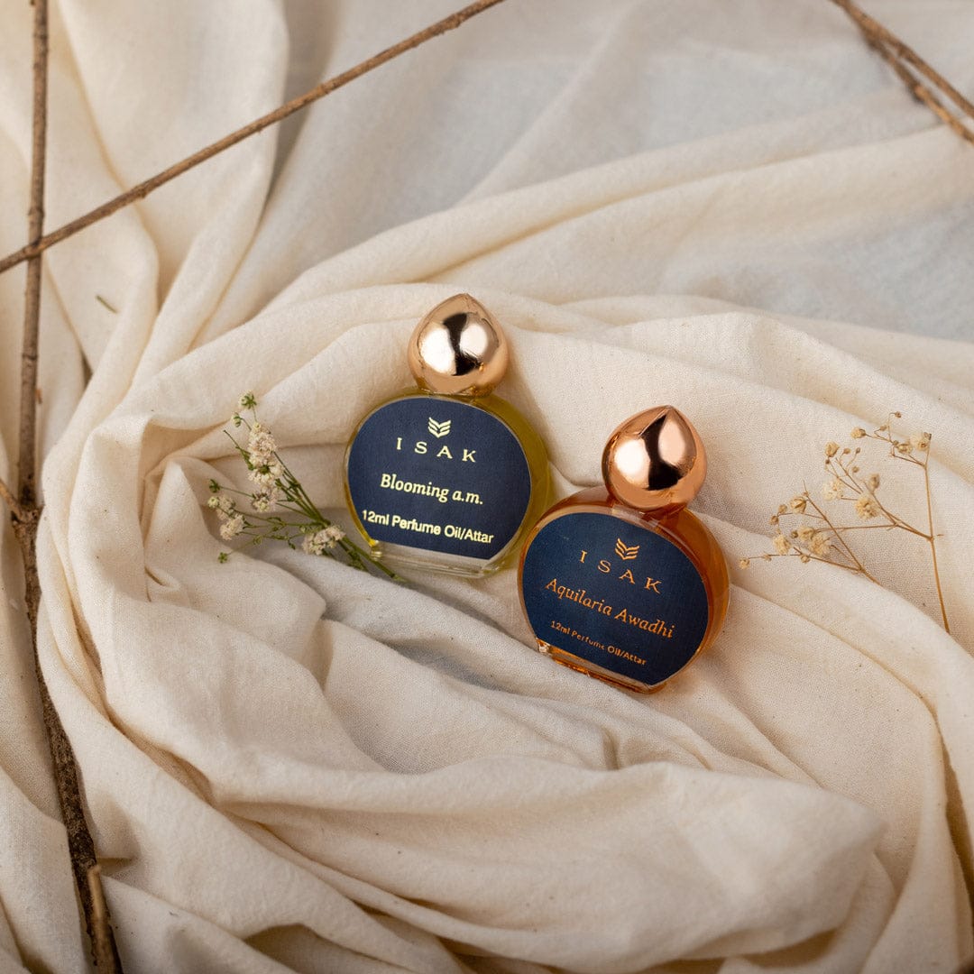 Gift Pack Attars: frascos pequeños con tapas doradas sobre tela crema